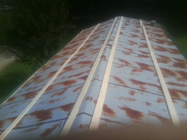 Rusted metal roof panels with new wood purlins before replacement — Storm Damage Roof Repair in Hardeeville by Roofing Brothers