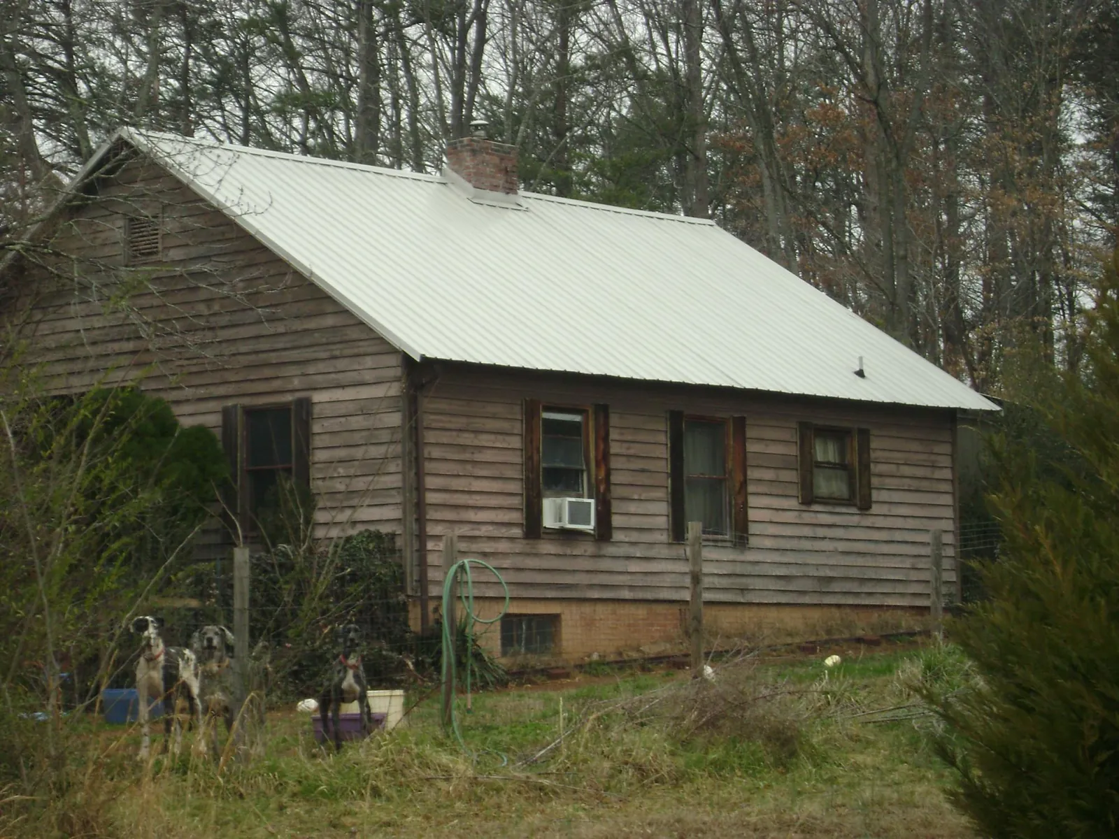 White metal roof on an old wood sided farmhouse, from a Metal Roof Installation job in Hardeeville